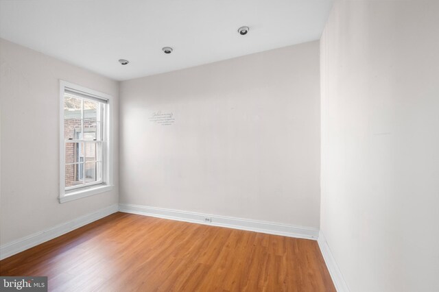 spare room with hardwood / wood-style floors