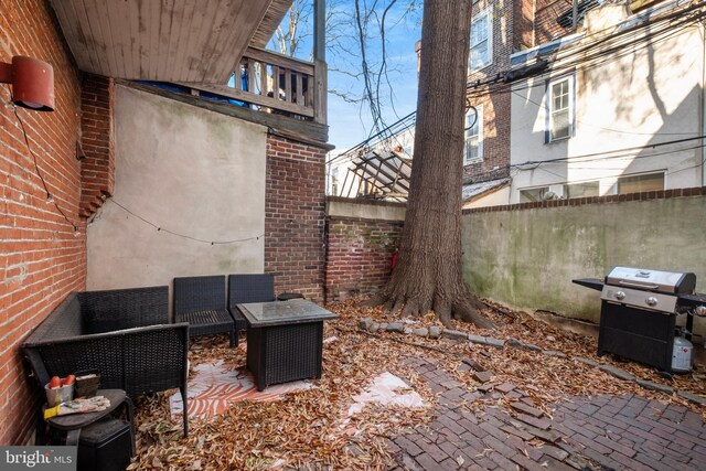 view of patio with area for grilling and an outdoor hangout area