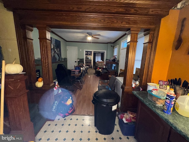 interior space featuring decorative columns, ceiling fan, and crown molding