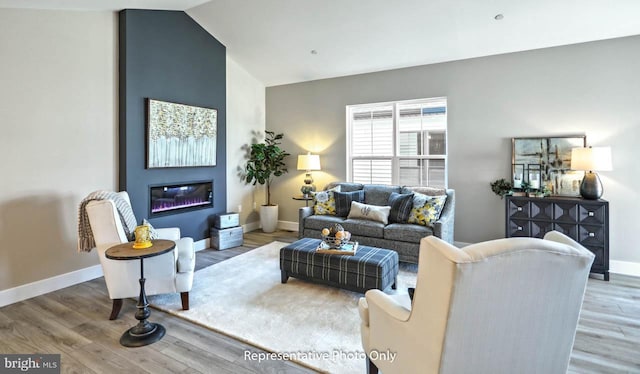 living room featuring hardwood / wood-style floors and vaulted ceiling