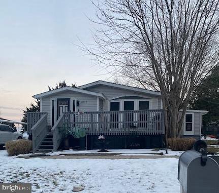 view of front of property with a wooden deck