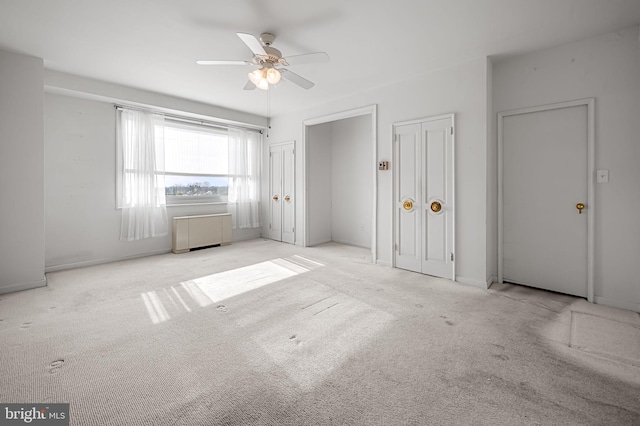 empty room with ceiling fan and light colored carpet