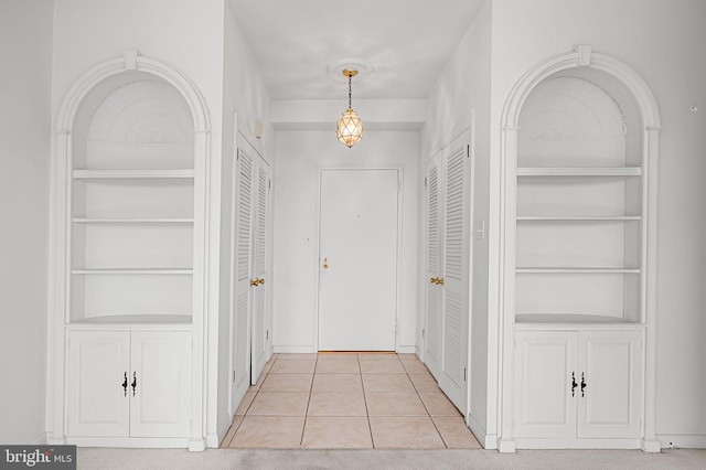 corridor featuring light tile patterned floors