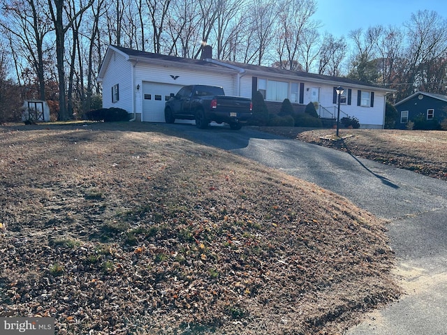 view of front of home with a front lawn and a garage