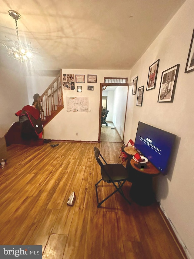 interior space with wood-type flooring and a notable chandelier