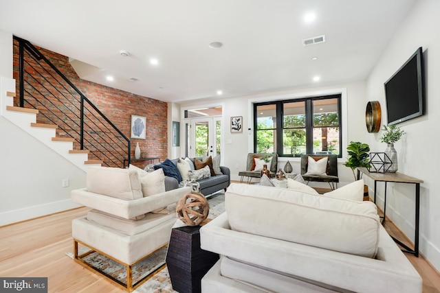 living room with french doors and light hardwood / wood-style flooring