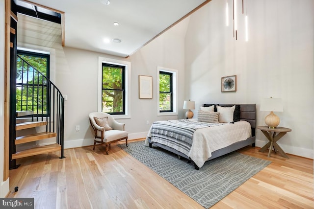 bedroom with light hardwood / wood-style flooring and ornamental molding