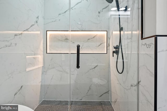 bathroom featuring a shower with shower door