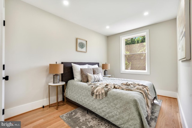 bedroom with hardwood / wood-style flooring