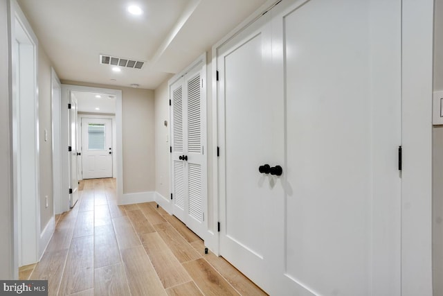 corridor with light wood-type flooring