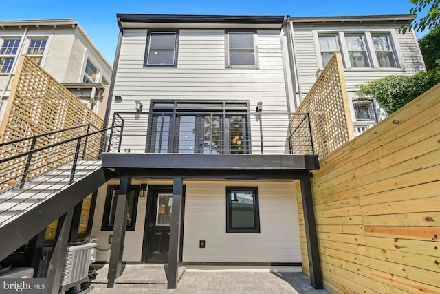 rear view of house featuring a balcony