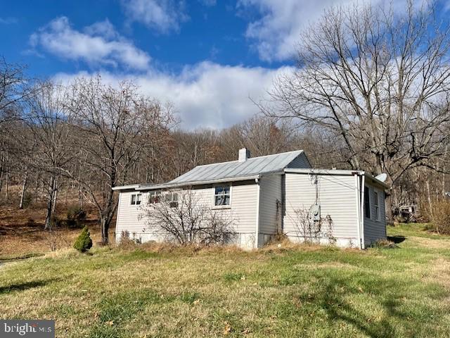 view of outbuilding with a yard