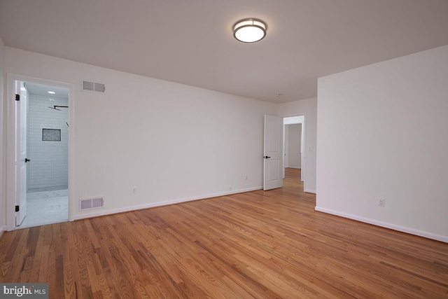 spare room featuring light hardwood / wood-style floors