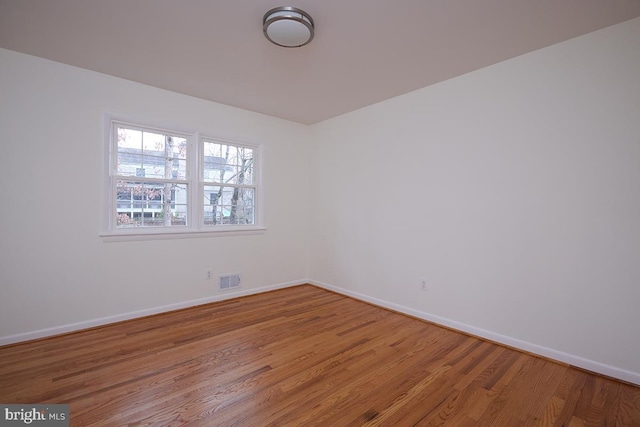 spare room featuring hardwood / wood-style floors