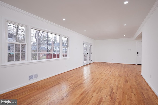 unfurnished room with light hardwood / wood-style floors, a wealth of natural light, and ornamental molding