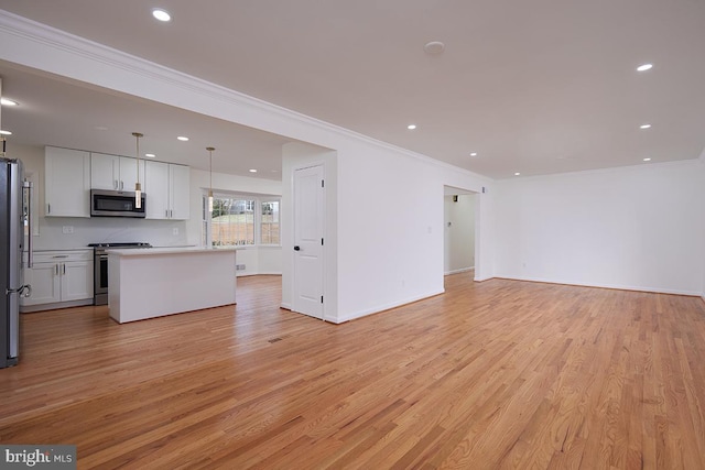 unfurnished living room featuring light hardwood / wood-style flooring and ornamental molding