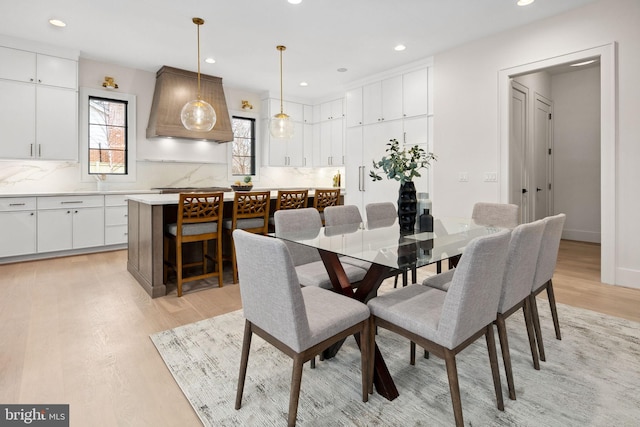 dining space featuring baseboards, recessed lighting, and light wood-style floors