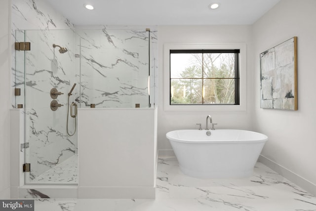 bathroom featuring marble finish floor, a marble finish shower, recessed lighting, a freestanding bath, and baseboards