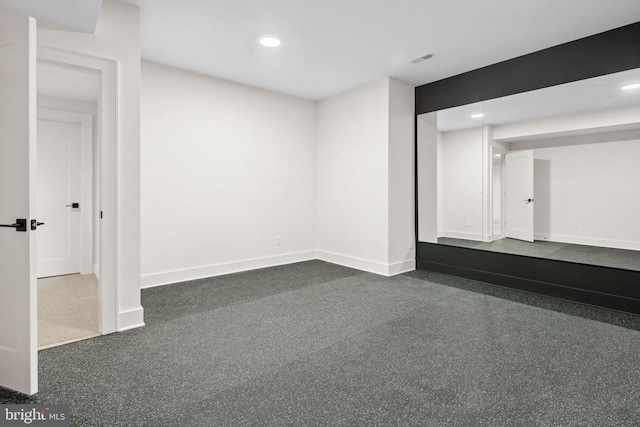 finished basement with visible vents, baseboards, and recessed lighting