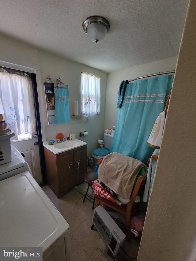 bathroom featuring vanity, a textured ceiling, and toilet