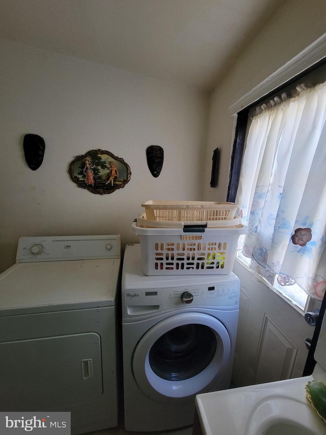 washroom with washing machine and clothes dryer