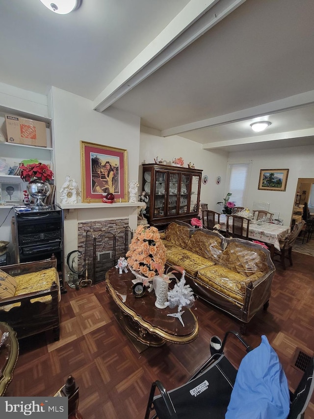 living room with beam ceiling, parquet floors, and a fireplace