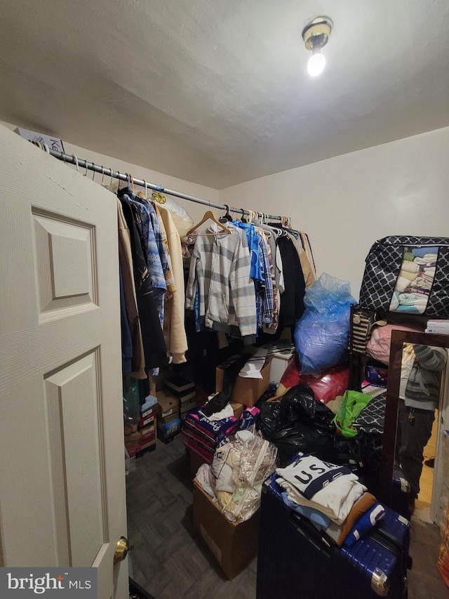 spacious closet with parquet flooring