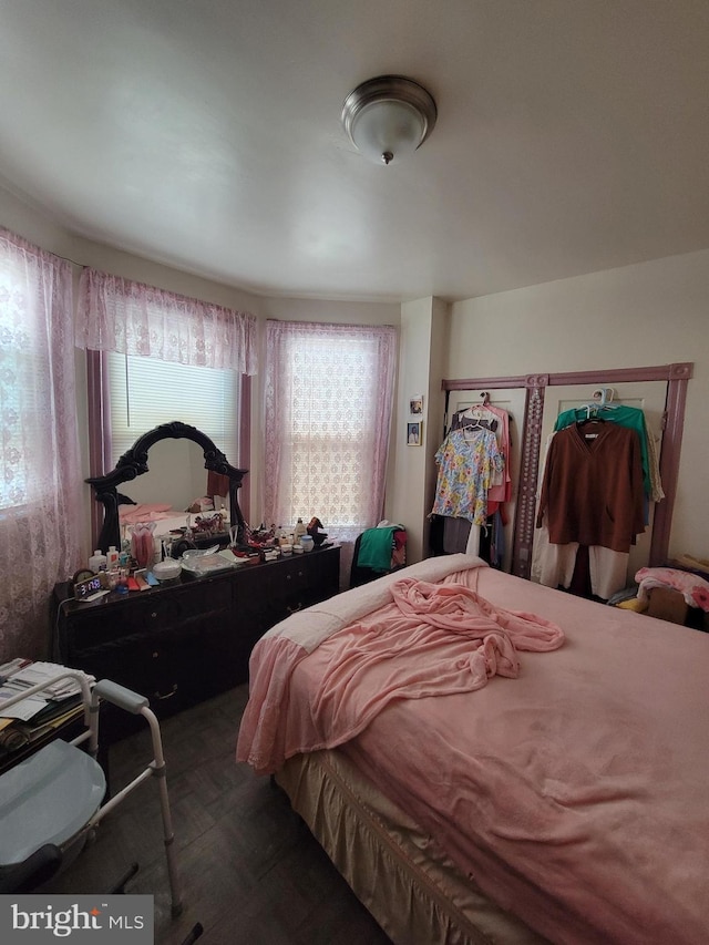 bedroom with dark parquet floors