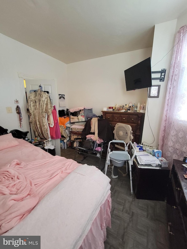 bedroom with dark parquet floors