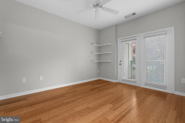 empty room with hardwood / wood-style floors and ceiling fan