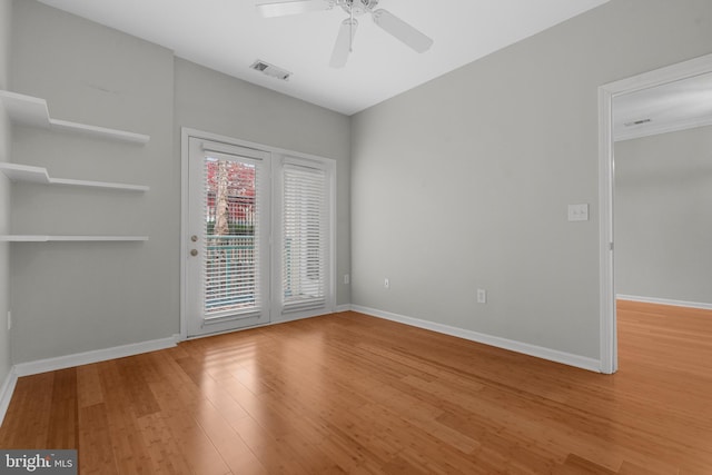 spare room featuring wood-type flooring and ceiling fan