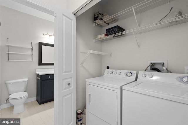 laundry room with washer and dryer and light tile patterned flooring