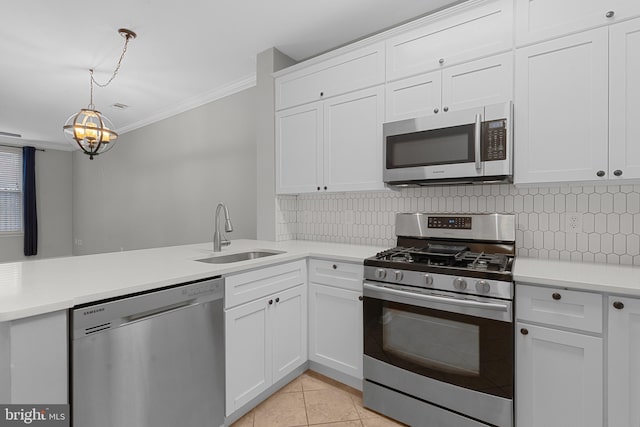 kitchen with ornamental molding, stainless steel appliances, sink, white cabinets, and light tile patterned flooring