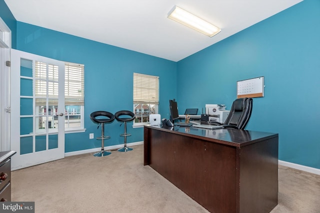 carpeted home office with french doors and plenty of natural light