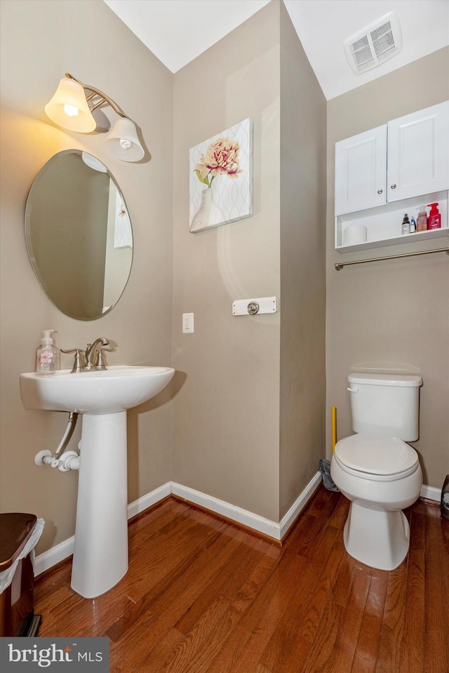 bathroom featuring hardwood / wood-style floors and toilet