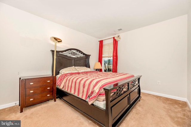 bedroom featuring light colored carpet