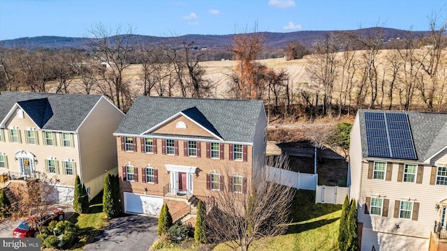 view of front of home featuring a mountain view and a garage