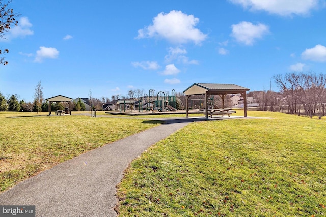 view of community featuring a gazebo, a playground, and a lawn