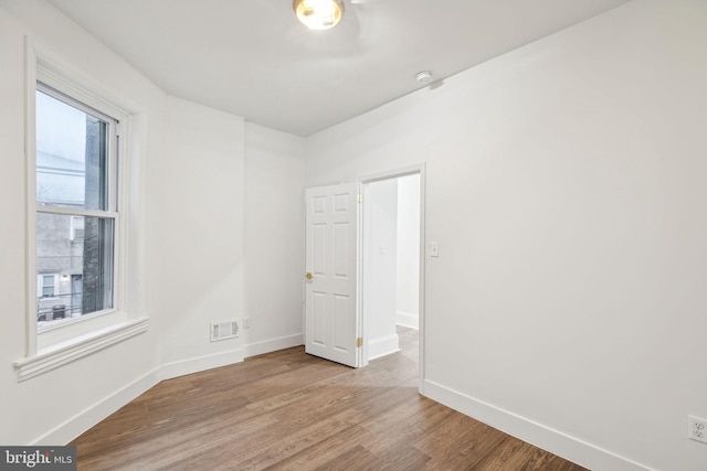 empty room featuring hardwood / wood-style flooring