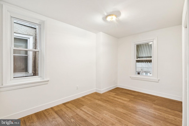 spare room with light hardwood / wood-style flooring