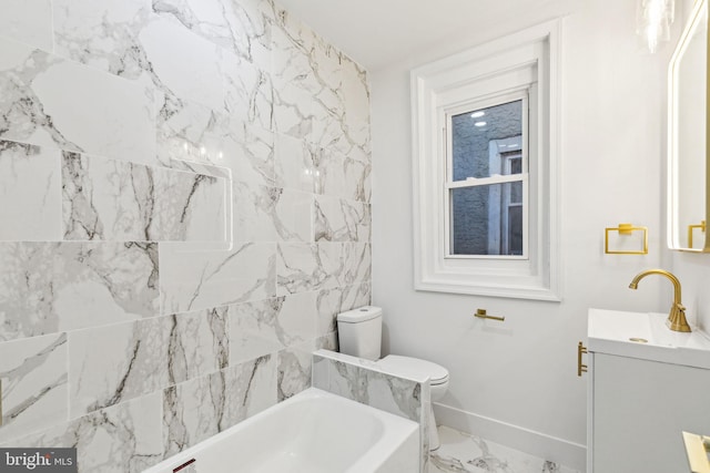 bathroom with vanity, toilet, and a bathtub