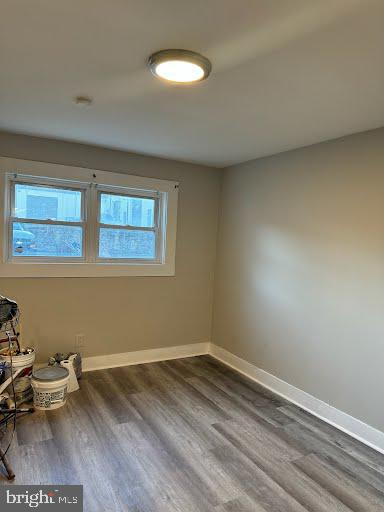 spare room featuring dark wood-type flooring and a wealth of natural light