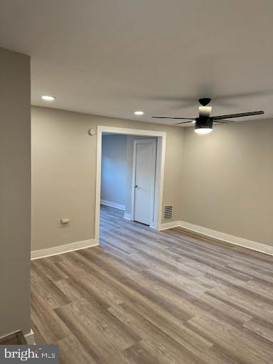 spare room featuring wood-type flooring and ceiling fan