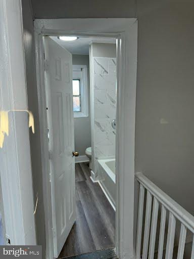 bathroom with hardwood / wood-style floors and toilet