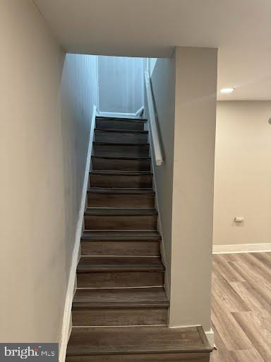 staircase with wood-type flooring