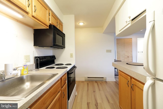 kitchen featuring electric range oven, a baseboard heating unit, white fridge, sink, and light hardwood / wood-style flooring