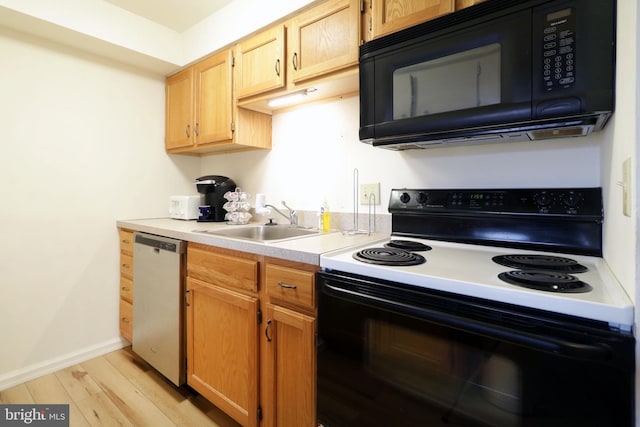 kitchen featuring sink, light brown cabinets, black appliances, and light wood-type flooring