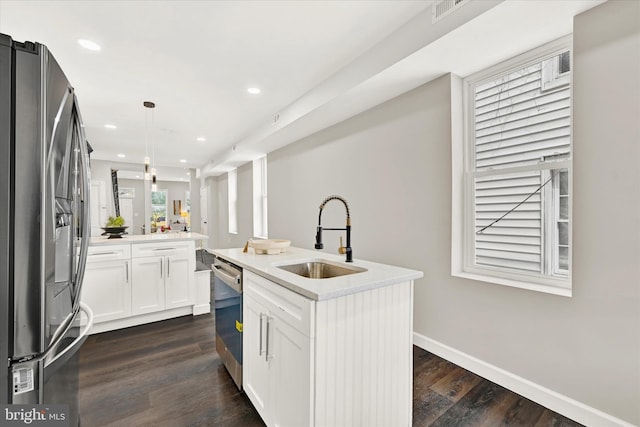 kitchen with a kitchen island with sink, sink, hanging light fixtures, white cabinetry, and stainless steel appliances