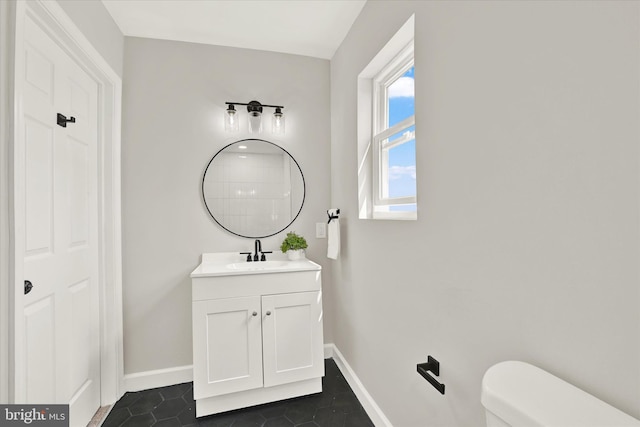 bathroom with tile patterned flooring, vanity, and toilet