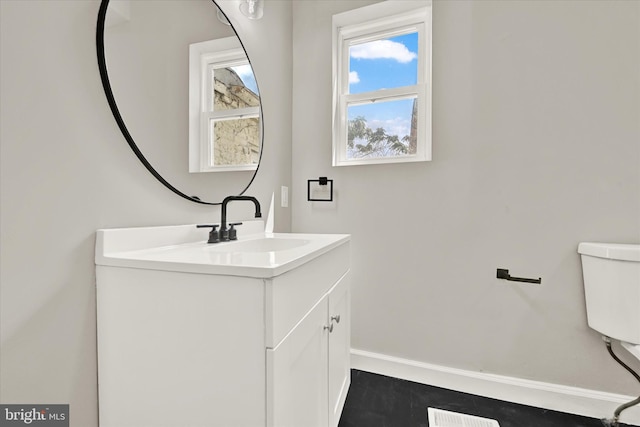 bathroom with vanity and toilet